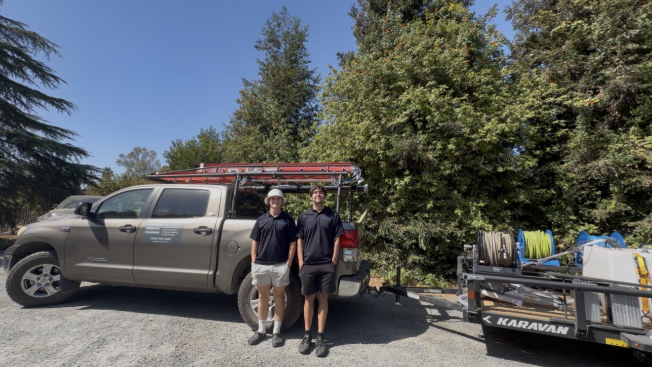 The Paneless Window Cleaning crew with their truck and equipment trailer
